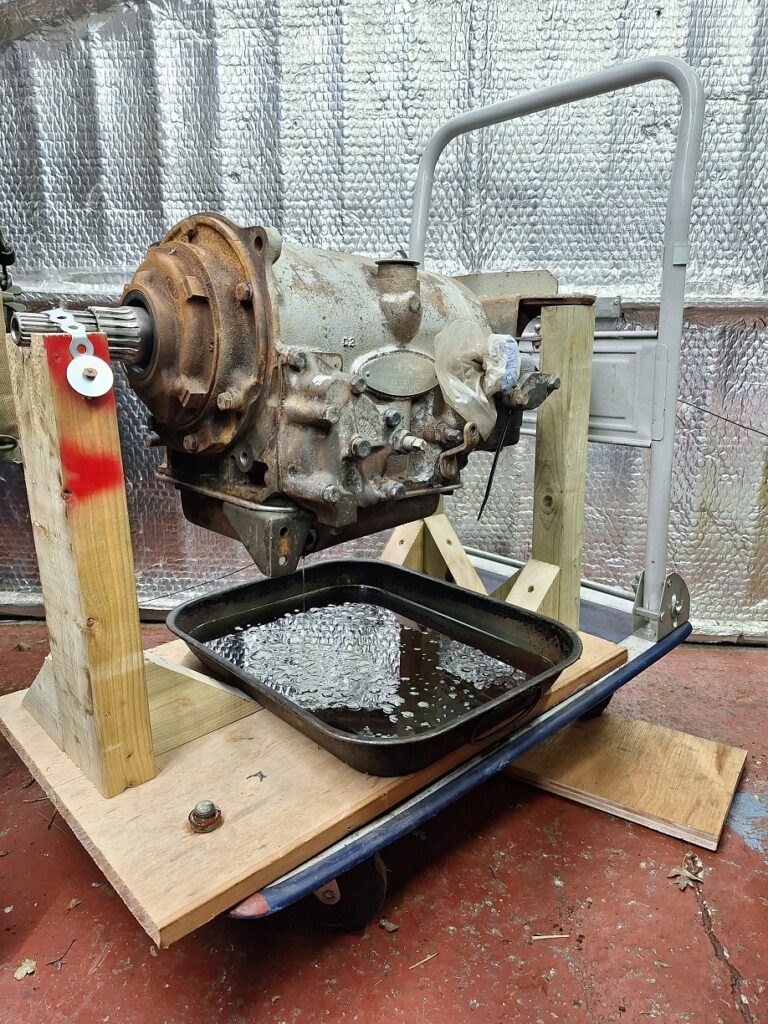 Gearbox on wooden stand to drain oil.